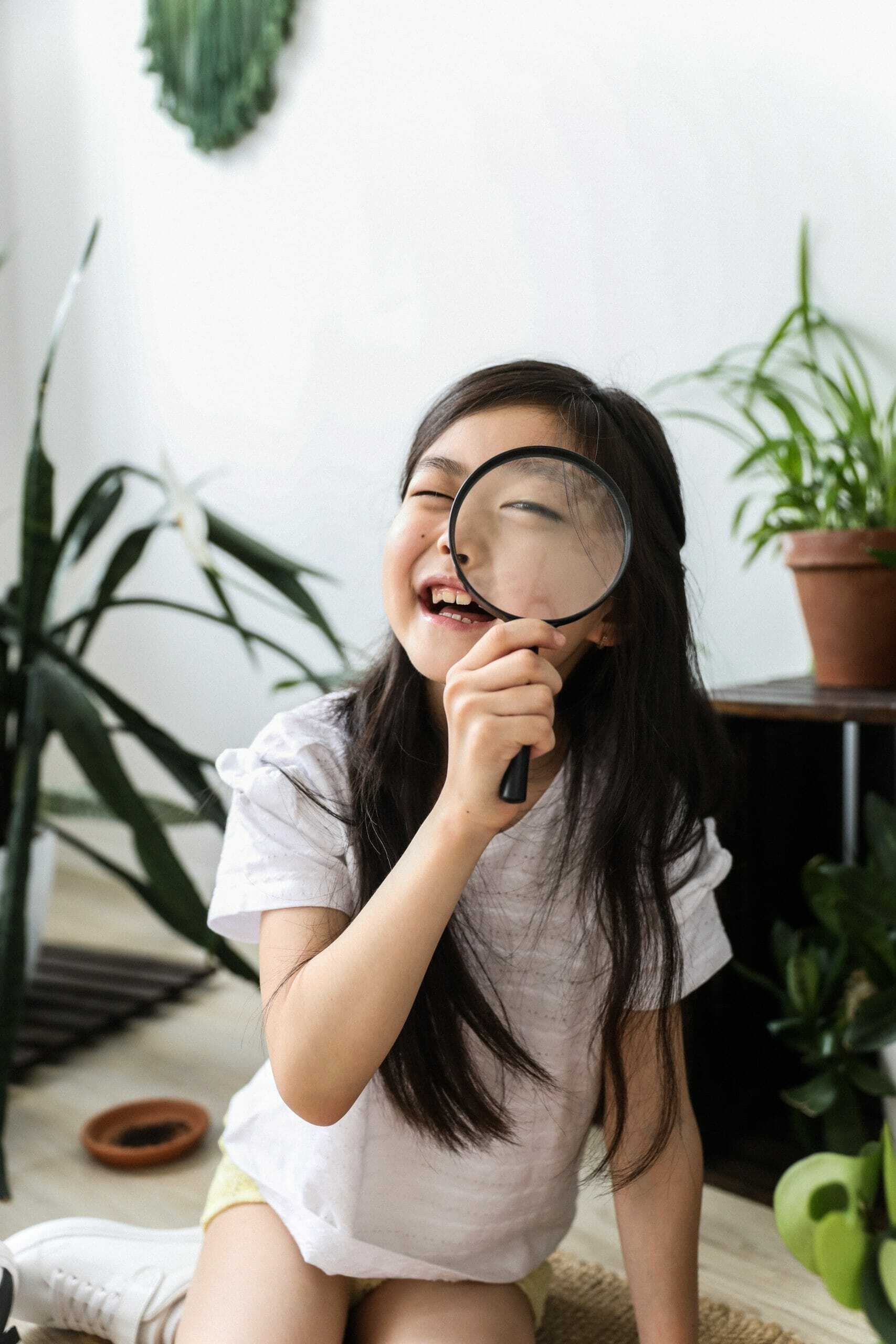 child with magnifying glass scaled